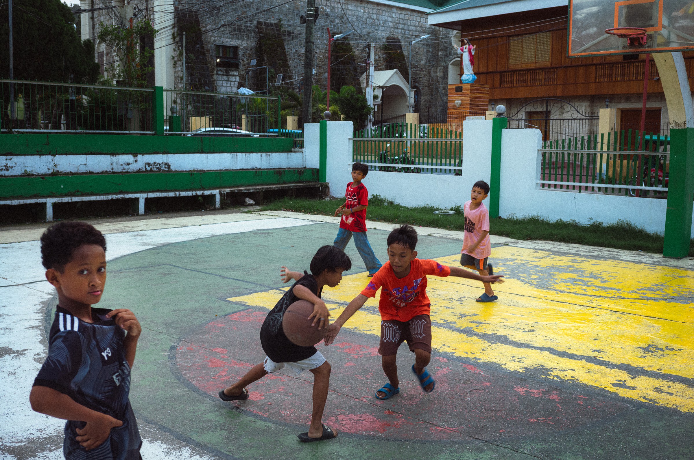Black and white street photography of a man walking past decorative Khiva wall, documentary photography by Evangelos Tzemis